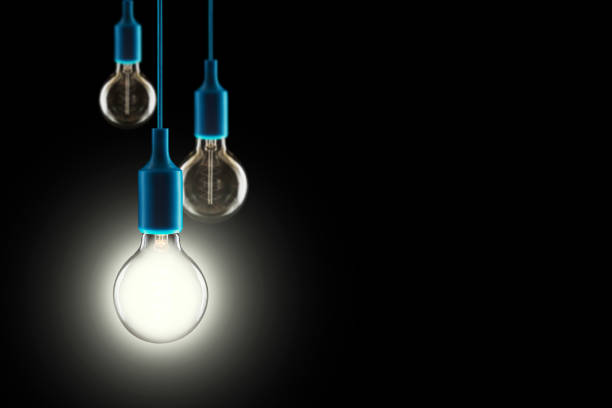 istock Idea and teamwork concept - Vintage incandescent bulbs on black background 1404337173