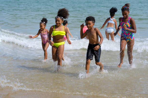 Kids are playing on the beach. Summer time with friends. Beach, sea and summer concept.