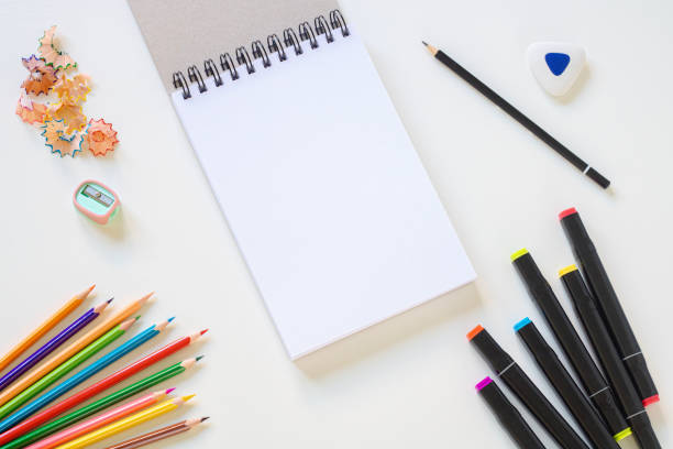 istock Open sketchbook, pencils, sharpener, eraser and markers. 1404337303