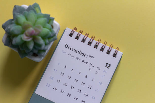 istock Desktop calendar for December 2022 on a yellow background. 1404340009