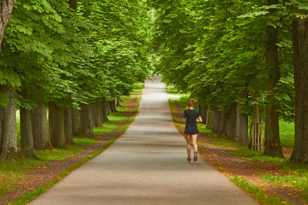 Ludwigsburg, Germany - June, 3 - 2022: Woman jogging in the park.