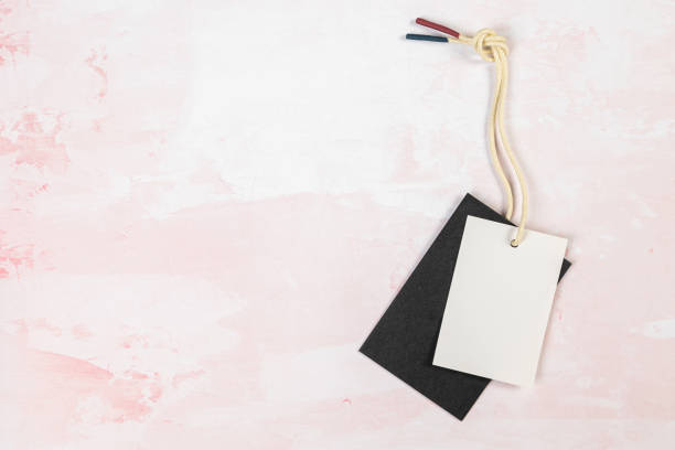 istock Clothing tag, label blank mockup template on a  pink table 1404340823