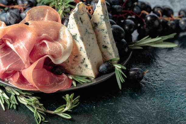 istock Prosciutto with blue cheese, grapes, and rosemary. 1404341381