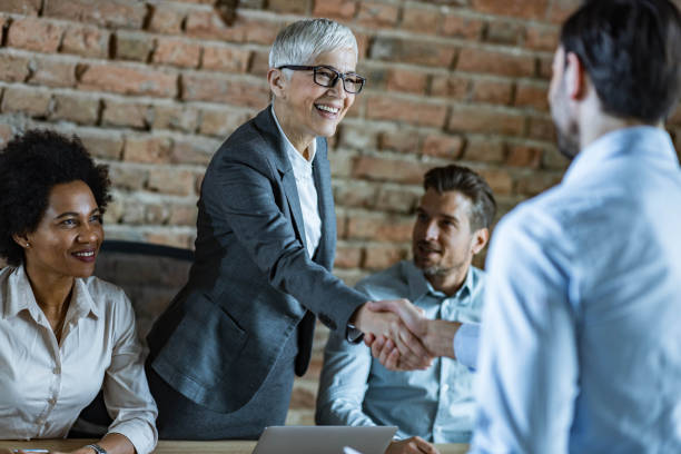 istock Human resource team welcoming a candidate on a job interview. 1404344147
