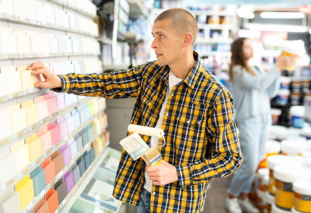 istock Young male customer choosing paint color for renovation works 1404344907