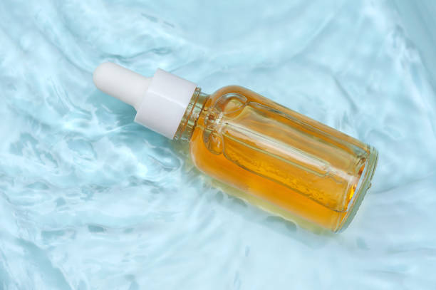 istock Facial serum on blue water background 1404345690
