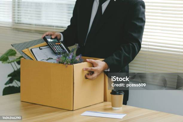 Resignationbusinessmen Packing Stuff Resign Depress Or Carrying Business Cardboard Box By The Desk In The Office Quitting A Job The Big Quit The Great Resignationunemployment Stock Photo - Download Image Now