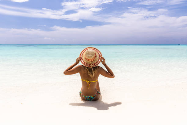 istock back view of relaxed woman looking at view from the beach. 1404346830