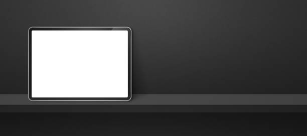 istock Digital tablet pc on black wall shelf. Background banner 1404348145