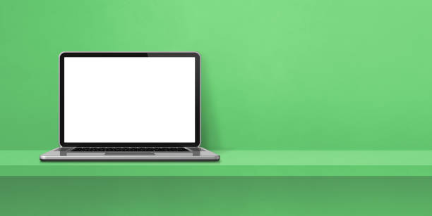 istock Laptop computer on green shelf background banner 1404348235