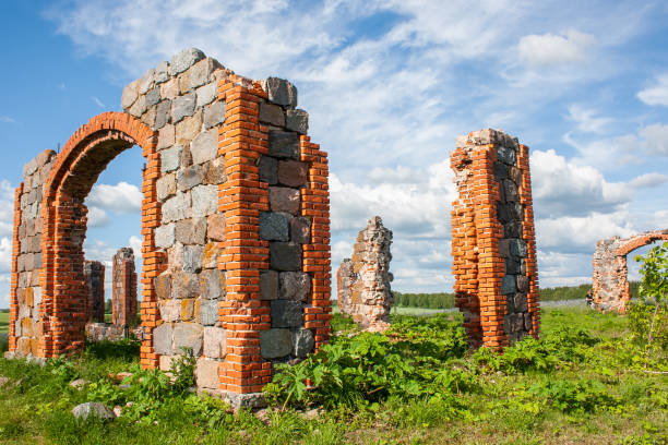 istock An old, dilapidated stone and brick building in a meadow under a dramatically cloudy sky. Old rural property. 1404348440