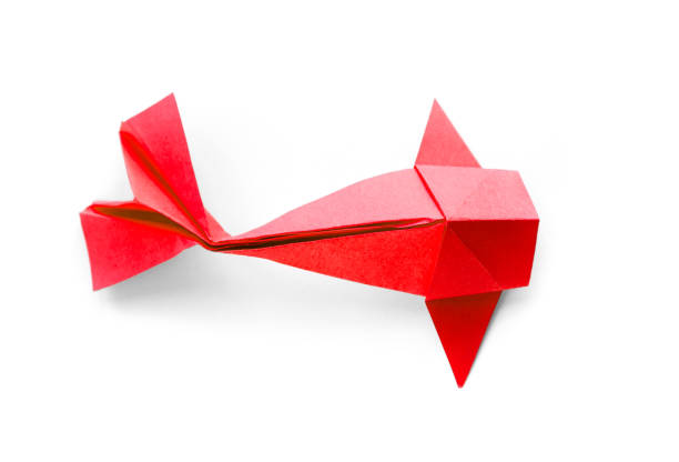 istock Red paper fish origami isolated on a white background 1404348462