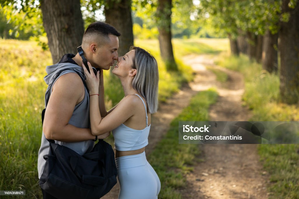Young couple, kissing int he nature, before or after their workout Caucasian young couple, kissing int he nature, before or after their workout 30-34 Years Stock Photo