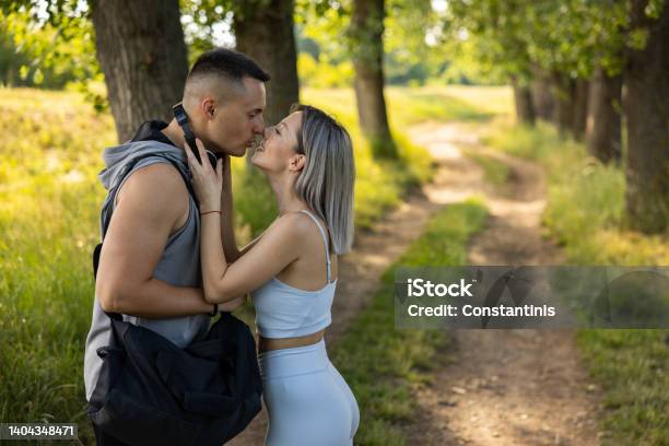 Young Couple Kissing Int He Nature Before Or After Their Workout Stock Photo - Download Image Now
