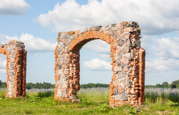 istock An old, dilapidated stone and brick building in a meadow under a dramatically cloudy sky. Old rural property. 1404348488
