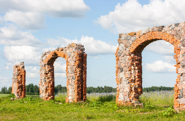 istock An old, dilapidated stone and brick building in a meadow under a dramatically cloudy sky. Old rural property. 1404348498
