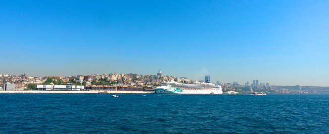 Istanbul, Turkey - Galataport, huge cruise ship can be seen on the right side. Galataport is a cruise ship port and mixed-use property in Karakoy district.