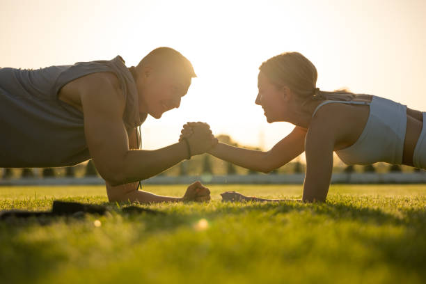 istock Active young couple, together exercising in the nature during sunset 1404351947