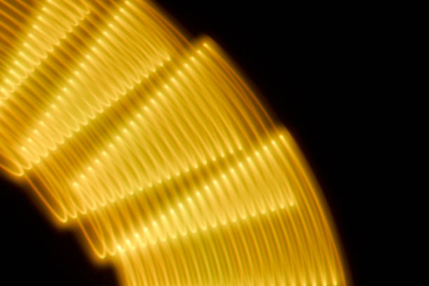 Abstract yellow light trails painting on a black background