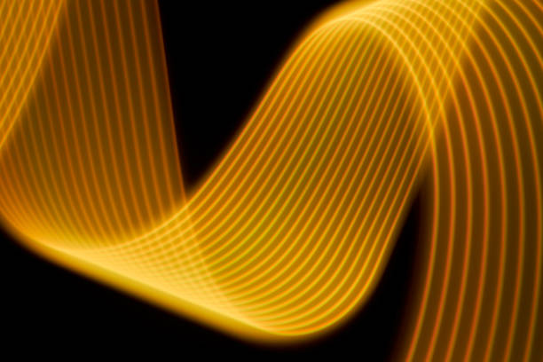 istock Abstract yellow light trails painting on a black background 1404352332