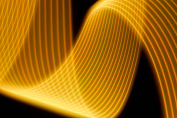 istock Abstract yellow light trails painting on a black background 1404352334