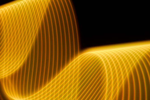 istock Abstract yellow light trails painting on a black background 1404352337