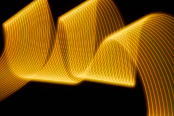 istock Abstract yellow light trails painting on a black background 1404352339