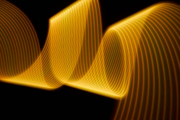 istock Abstract yellow light trails painting on a black background 1404352342