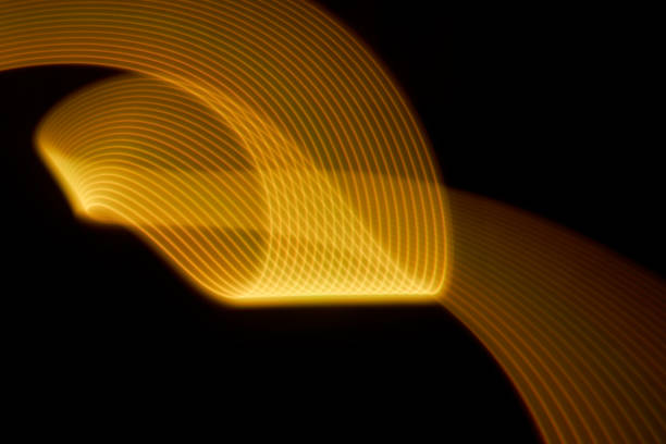 istock Abstract yellow light trails painting on a black background 1404352345