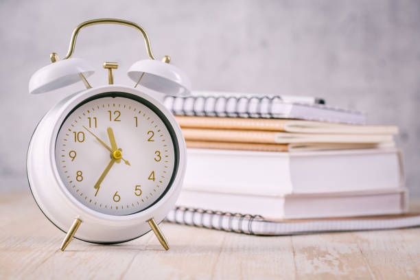 istock Time management concept for schoolers and students. Books with clock 1404352480