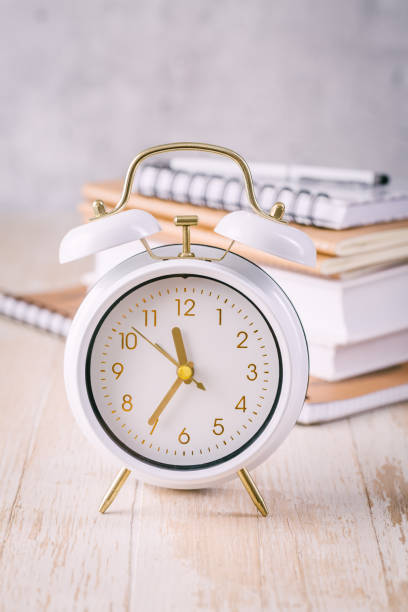 Time management concept for schoolers and students. Books with clock