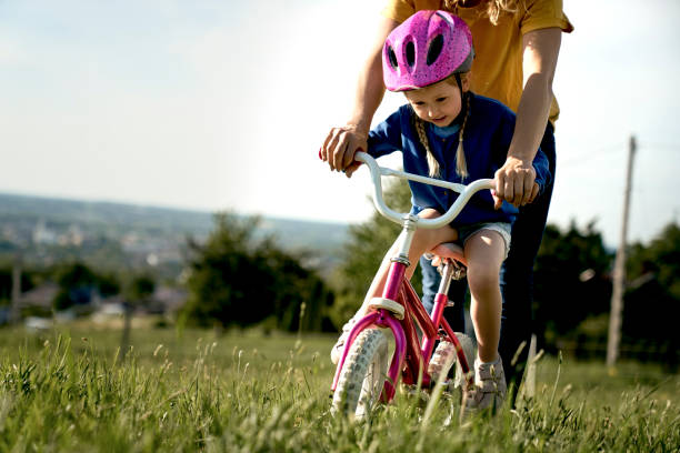istock Caucasian toddler learning how to ride bike 1404352661