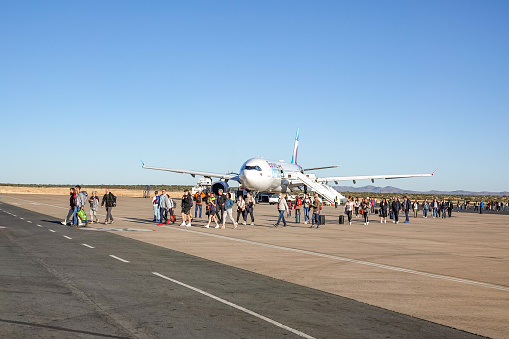 Passengers walking off a Eurowings Airline at Hosea Kutako International Airport of Windhoek in Khomas Region, Namibia. This is a German airline owned by Lufthansa.