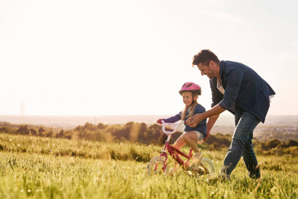 istock Caucasian toddler learning how to ride bike 1404353543