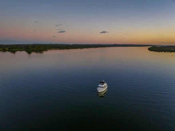 istock Sunset over the river with boats, reflections and the moon 1404355391