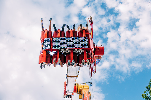 People on a extreme attraction at the amusement park. Entertainment, adrenaline and fun concept.
