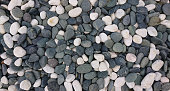 istock Black and white color pebbles stone background photo 1404364658