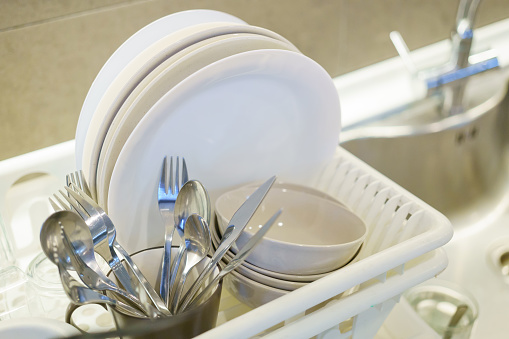 The kitchen dishes and utensils drying on a rack