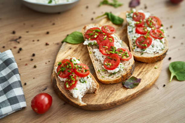 istock Bitten sandwich with cottage cheese  on wooden board 1404365626
