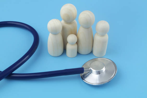 istock Family people figures with stethoscope on blue background close-up. 1404366501