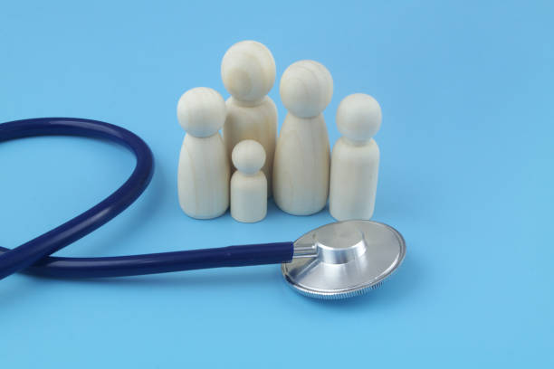 istock Family people figures with stethoscope on blue background close-up. 1404366537