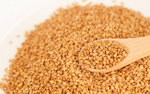 Sesame seeds and spoon Sesame seeds and spoon sesame seed stock pictures, royalty-free photos & images