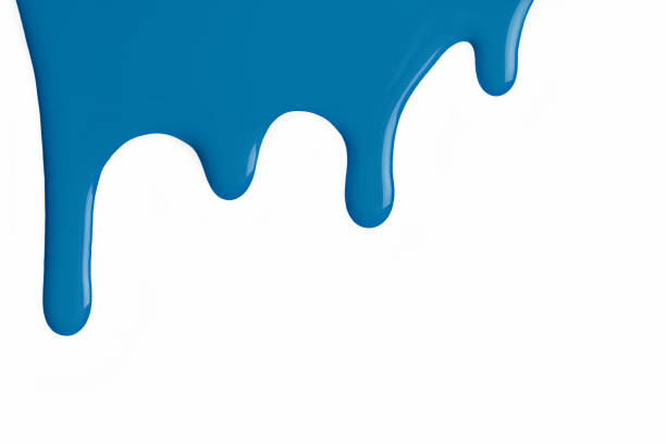 istock Light blue liquid drops of paint color flow down on isolated white background. Abstract denim backdrop 1404367837