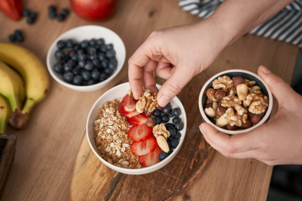 istock Woman preparing bowl with yogurt for breakfast 1404368424
