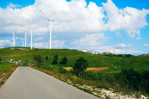 Mountain road along the windmill farm. Green Energy Sources