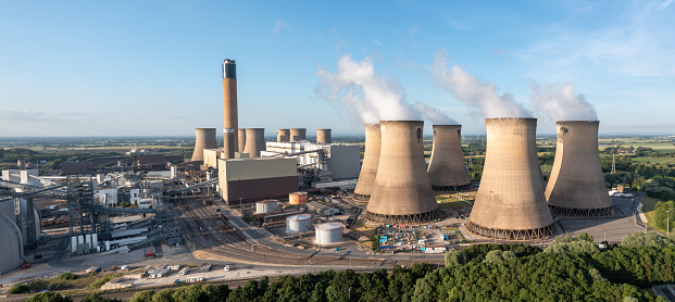An aerial view of a coal fired Power Station with cooling towers and chimney generating non renewable electricity and air pollution via carbon dioxide emissions