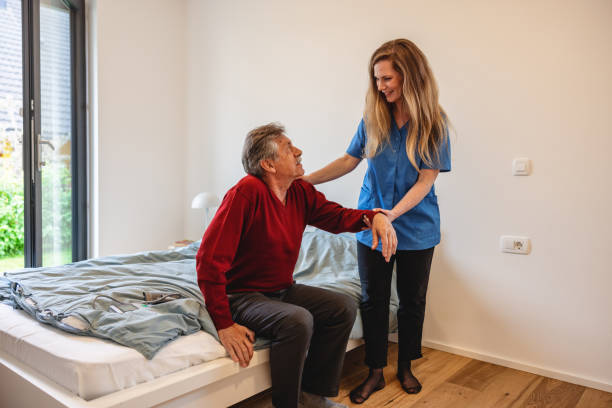 istock Nurse Helping a Senior Patient With Standing Up At Home 1404375328