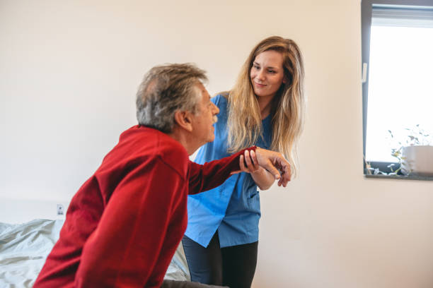 istock Nurse Helping a Senior Patient With Standing Up At Home 1404375341