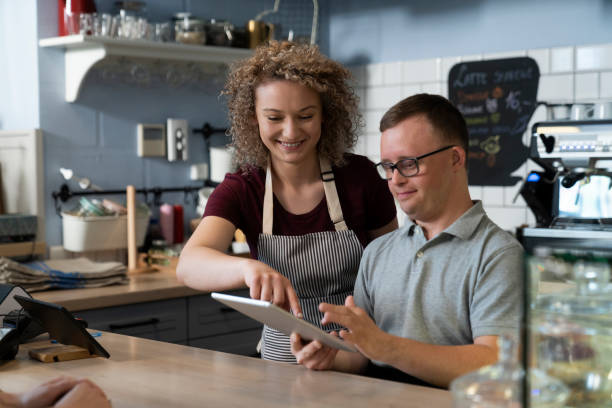 istock Caucasian man with down syndrome learning how to take orders 1404377426