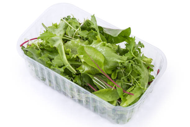 istock Mix of fresh greens in plastic container on white background 1404378248